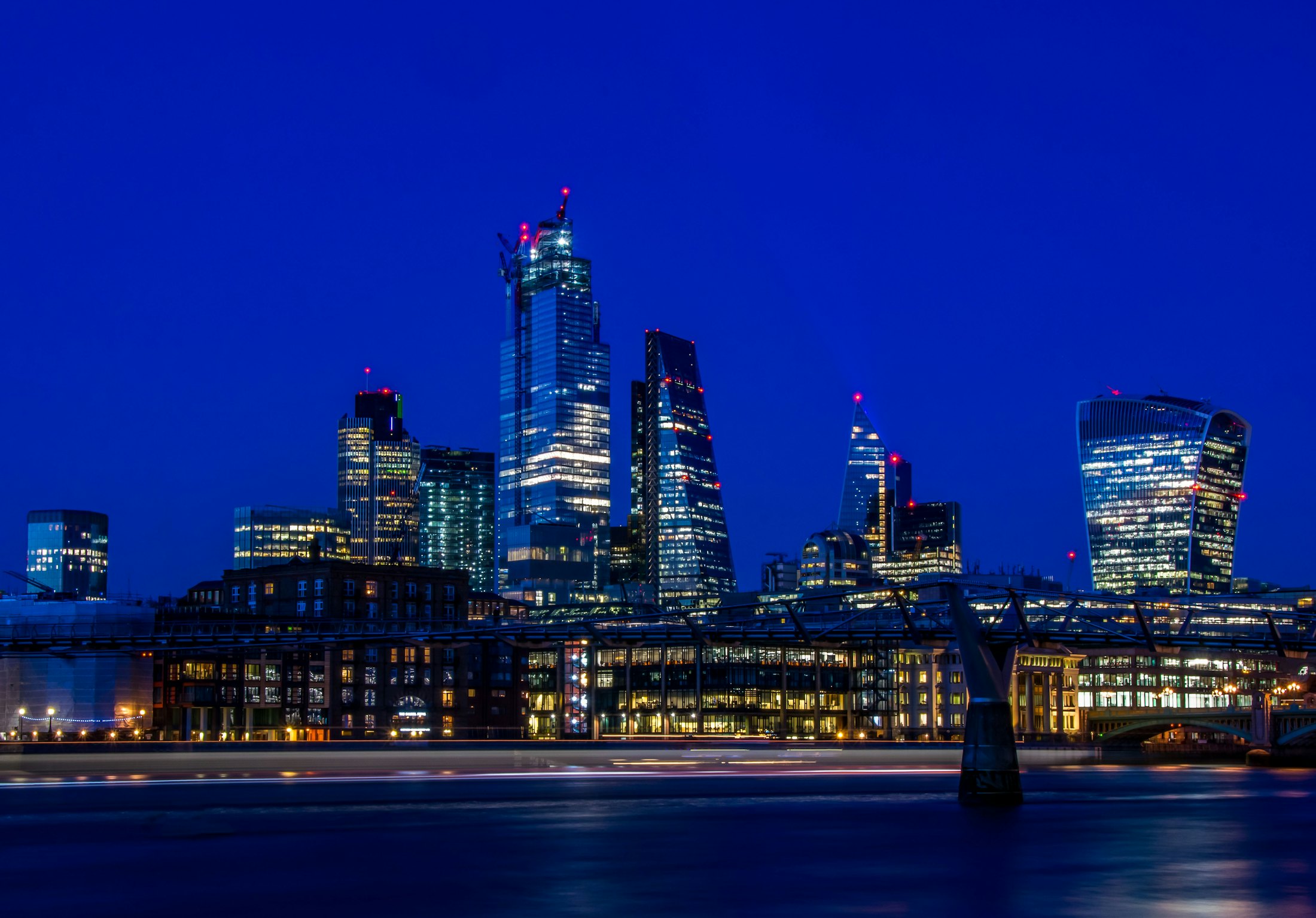 The City of London skyline lit up at blue hour